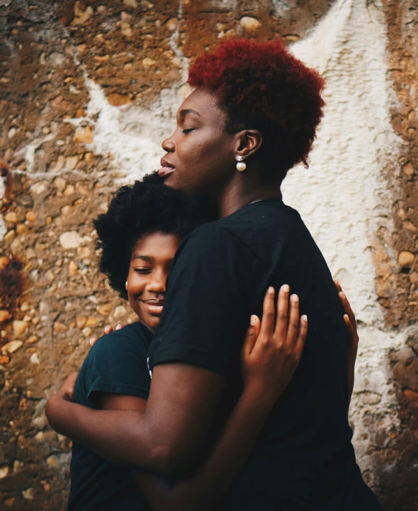 Photo of mother hugging daughter to represent benefits of family support throughout teen mental health therapy