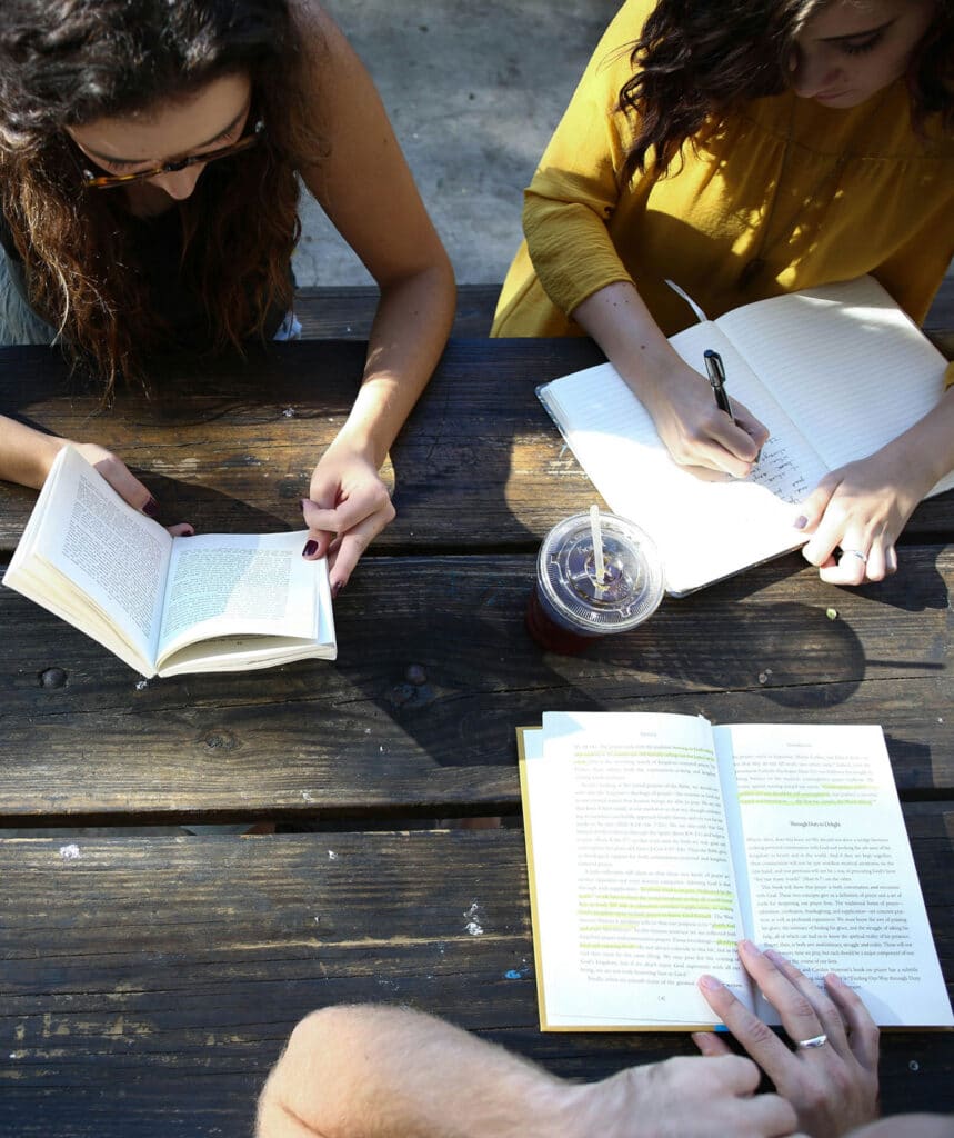 Group of teens sitting at a picnic table